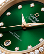 OMEGA Seamaster Aqua Terra 150M 30mm, Moonshine™ gold on Moonshine™ gold Watch, with a Diamond Bezel and Green Dial with Diamond Markers on a Moonshine™ gold integrated bracelet.