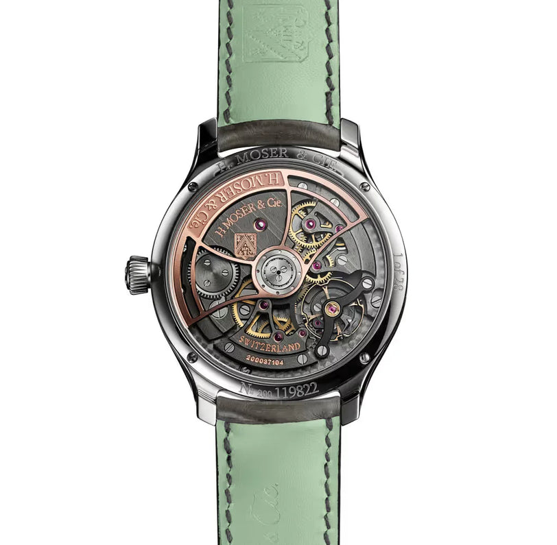 Stainless steel watch with exposed skeleton movement, small seconds dial, and mint green leather strap with contrast stitchin