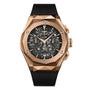 The Hublot Classic Fusion Aerofusion King Gold features a rose gold case, black skeleton dial with visible gears, two subdials, and a black rubber strap—exemplifying modern luxury in every detail.