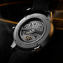 Close-up of the Girard-Perregaux Free Bridge Meteorite’s back, showcasing its avant-garde design, exposed movement, detailed engravings, and black leather strap.