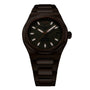 The Girard-Perregaux Laureato 42, a dark metal wristwatch with a round face, luminous hour markers, date at 3 o’clock, and link bracelet, is shown on a white background.