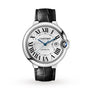 The Ballon Bleu de Cartier by Cartier features a silver round face, black Roman numerals, blue hands, date window, and black leather strap—showcasing timeless elegance against a white background.