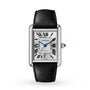 The Cartier Tank Must de Cartier is a rectangular mechanical watch with a black calfskin strap, silvered flinqué dial, Roman numerals, blue steel hands, and a date display at the bottom.