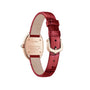The Cartier Baignoire luxury watch features a red leather strap, gold buckle, and an engraved gold case back with product details and water resistance information.
