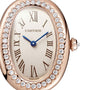 Close-up of the Cartier Baignoire watch featuring Roman numerals, blue hands, and a diamond-encrusted rose gold bezel.