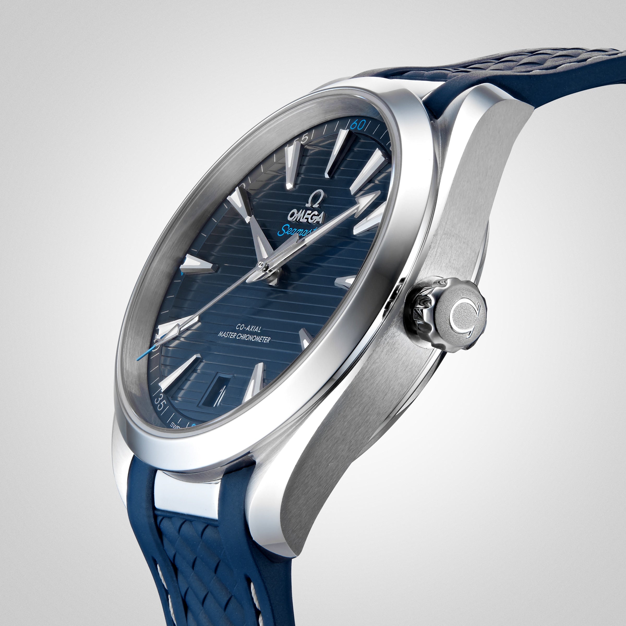An OMEGA Seamaster Aqua Terra 150M wristwatch with a blue textured dial, silver hour markers, and a blue rubber strap is displayed on a light background.