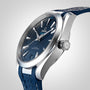 An OMEGA Seamaster Aqua Terra 150M wristwatch with a blue textured dial, silver hour markers, and a blue rubber strap is displayed on a light background.