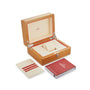 Open wooden OMEGA watch box with cream interior, cream cardholder, and red booklet arranged beside it—ideal for storing your Seamaster Aqua Terra 150M timepiece.