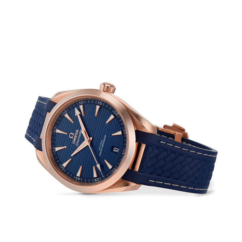 The OMEGA Seamaster Aqua Terra 150M is a rose gold wristwatch with a blue textured dial, date display, and blue rubber strap, powered by a Master Chronometer 8800 movement, shown against a plain white background.