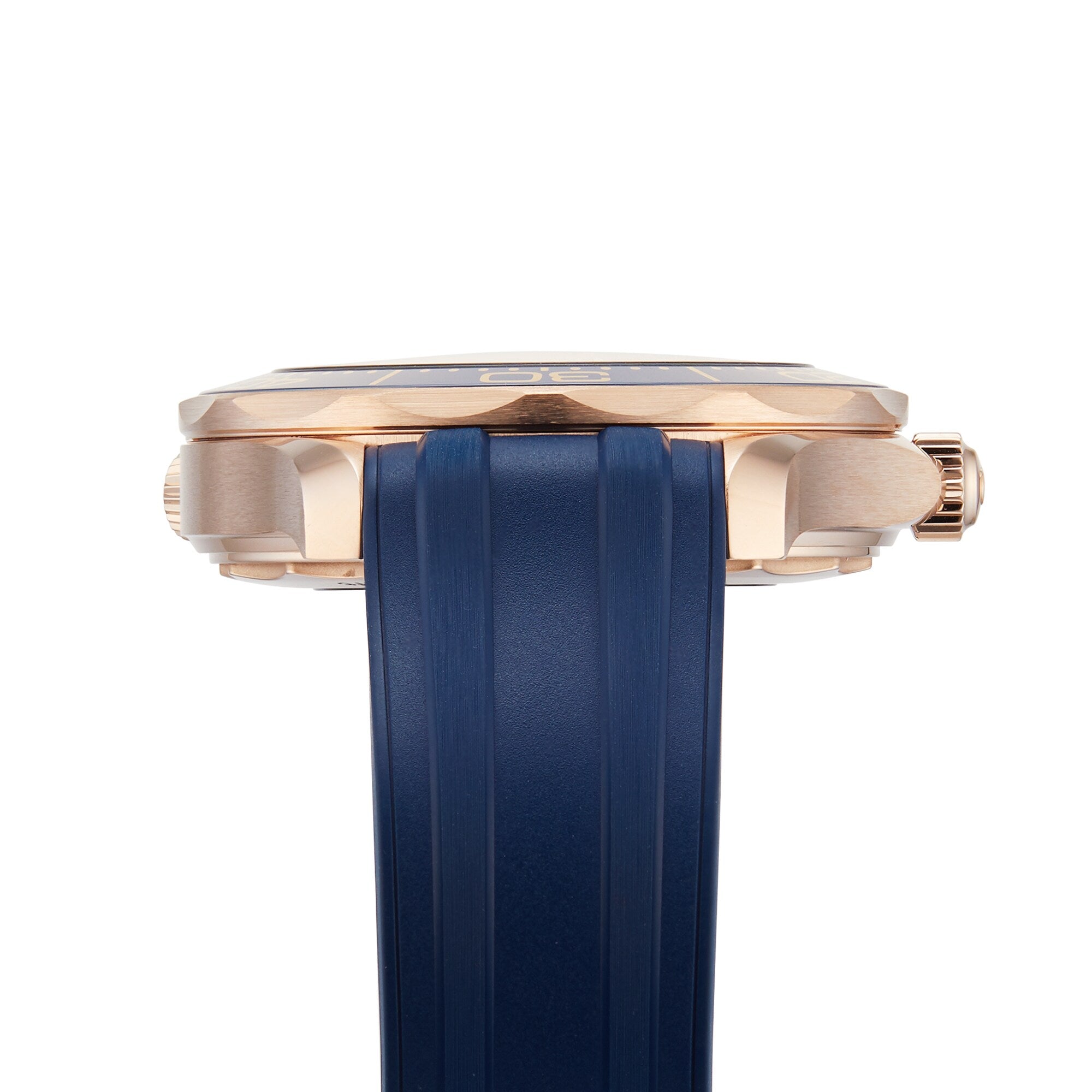 Side view of the OMEGA Seamaster Diver 300M with a gold case, right-side crown, and blue rubber strap against a white background—a style icon famously linked to James Bond.