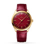 An OMEGA De Ville Trésor gold wristwatch with a red dial, gold markers and hands, and a red leather strap, powered by the Calibre 8910 Master Chronometer, is shown on a white background.