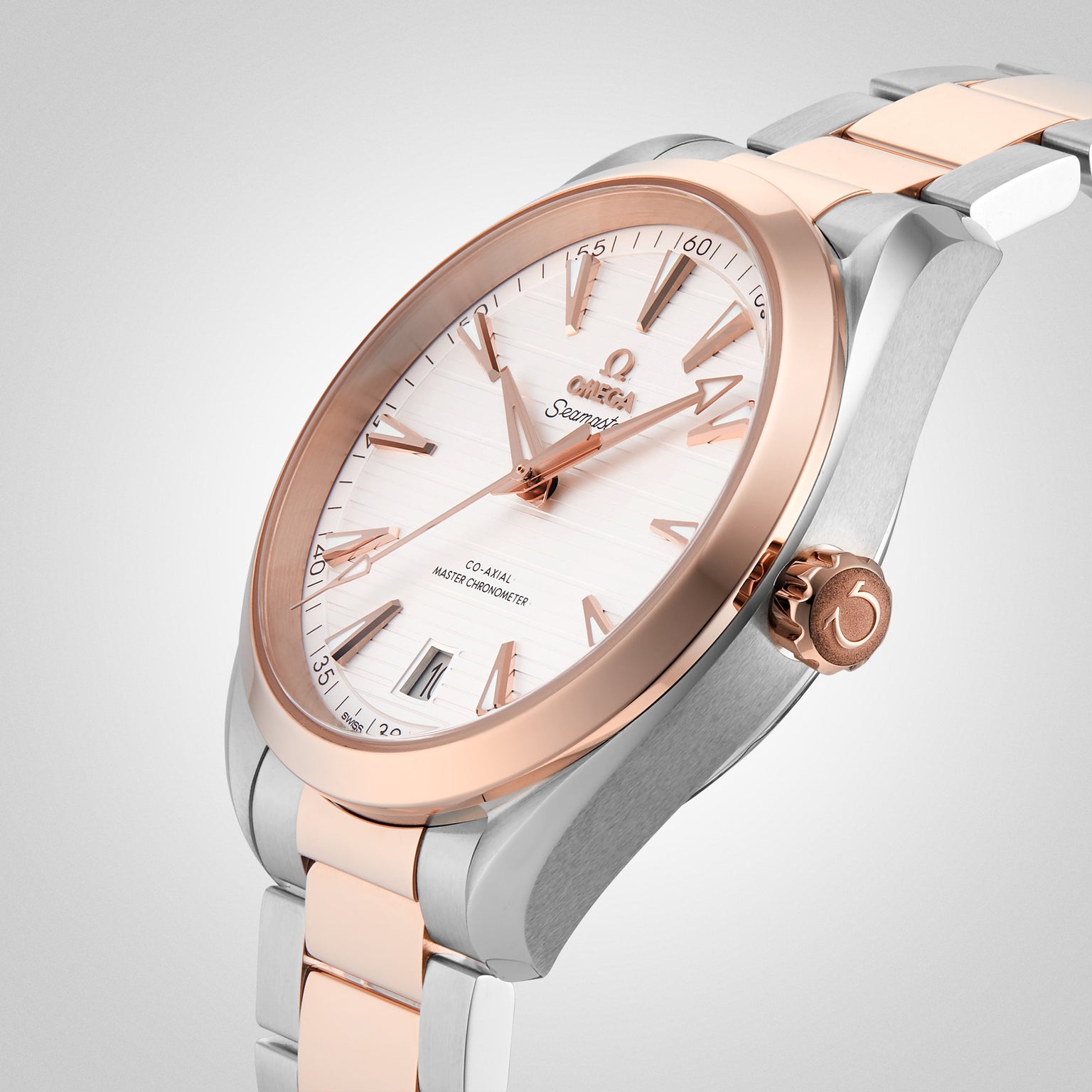 A close-up of an OMEGA Seamaster Aqua Terra 150M wristwatch with a silver and Sedna™ gold metal band, white dial, and rose gold markers and bezel.
