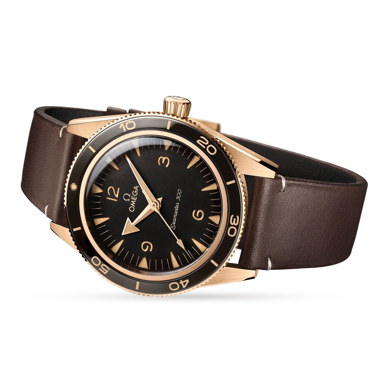 The OMEGA Seamaster 300 features a bronze gold case, black dial, gold markers, rotating bezel, and a brown leather strap. Displayed on a white background, it’s powered by the OMEGA Co-Axial Master Chronometer movement for precision.