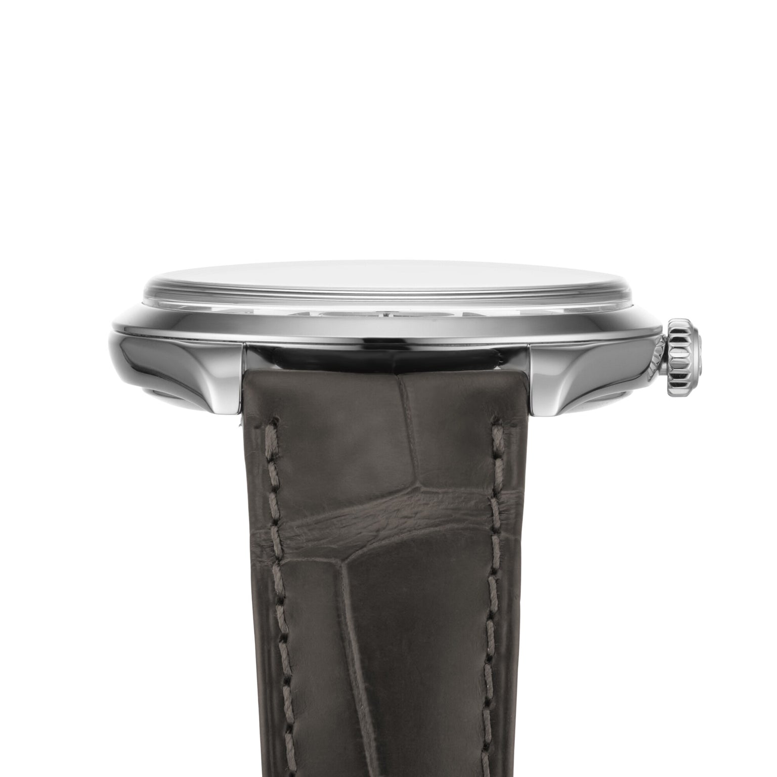 Side view of the OMEGA De Ville Trésor wristwatch with a slim stainless steel case, right-side crown, and dark textured leather strap. This elegant timepiece is Master Chronometer certified.