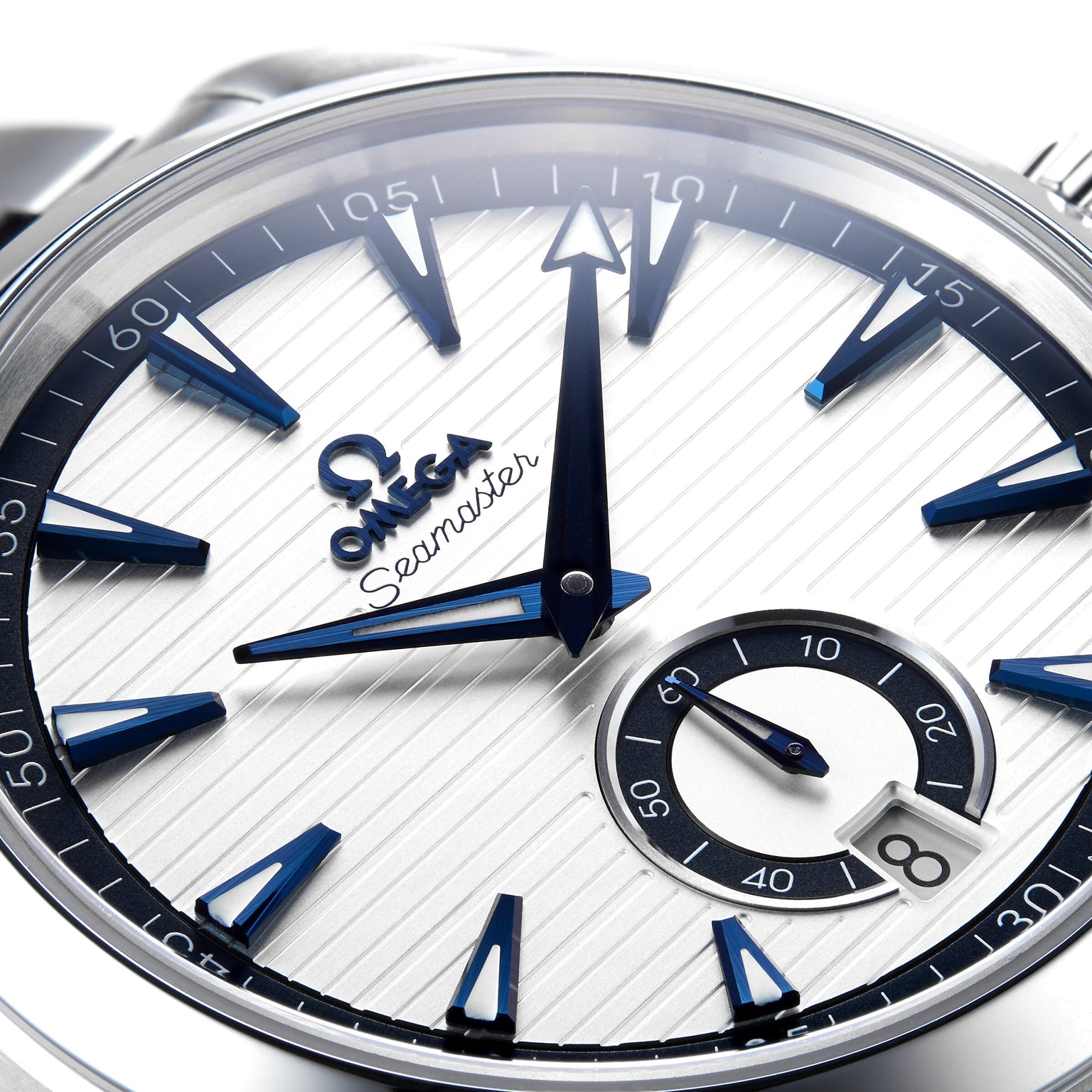 Close-up of the OMEGA Seamaster Aqua Terra 150M watch face at 12:00, featuring blue hands, hour markers, and a small seconds subdial at 6 o’clock—a striking nod to OMEGA’s maritime legacy.