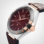 The OMEGA Constellation is a luxury watch with a brown dial, rose gold accents, Roman numerals, and a brown leather strap, featuring Master Chronometer certified 8900 calibre and classic Constellation heritage.