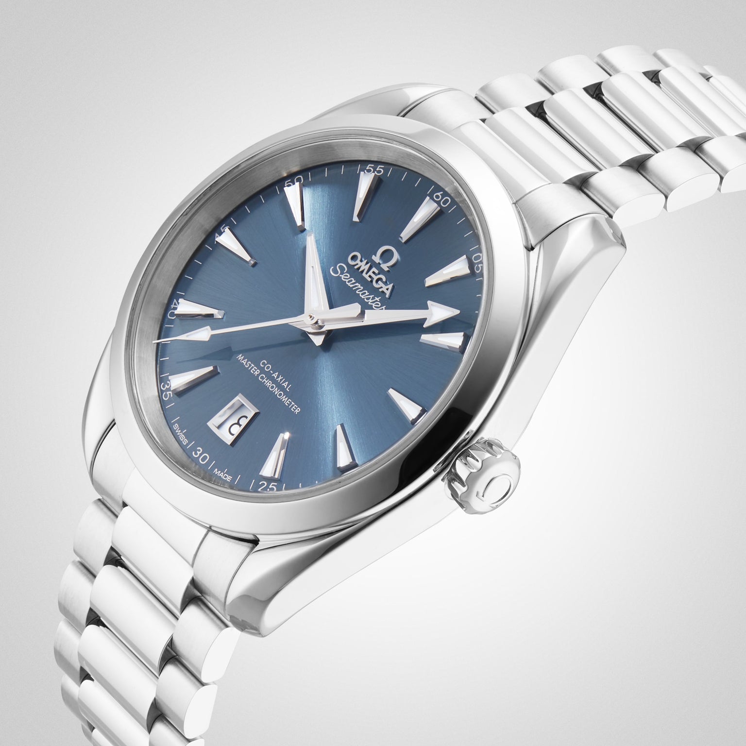 The OMEGA Seamaster Aqua Terra 150M, a stainless steel wristwatch with blue dial, silver markers, date at 6 o’clock, and metal bracelet is displayed against a light background.