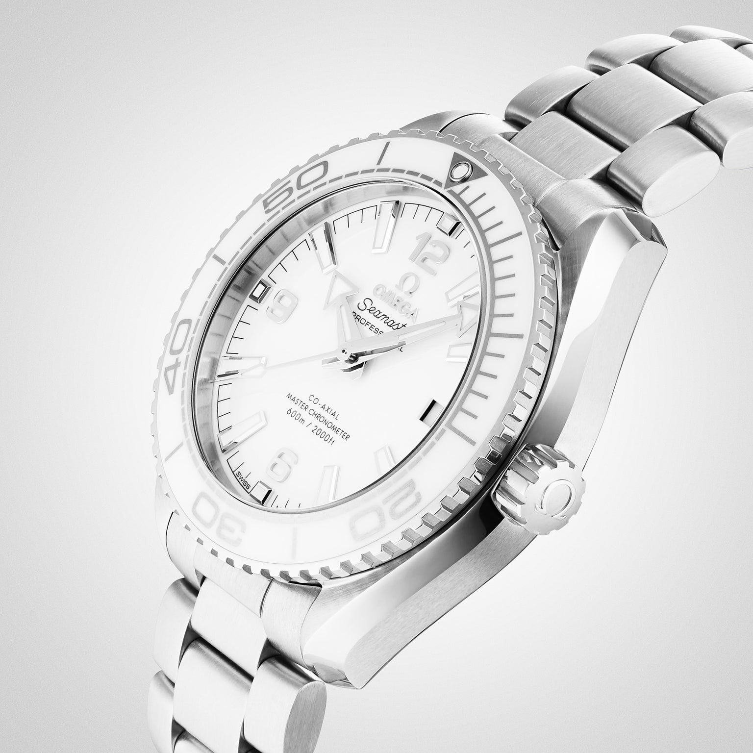 The OMEGA Seamaster Planet Ocean 600M, featuring a stainless steel case, white dial, white ceramic bezel, metal bracelet, and visible hour markers, is shown on a light background.