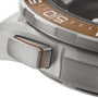 Close-up of the OMEGA Speedmaster X‑33 Marstimers silver titanium case, highlighting its crown with an orange accent stripe and a partial view of the bezel marked with 50.