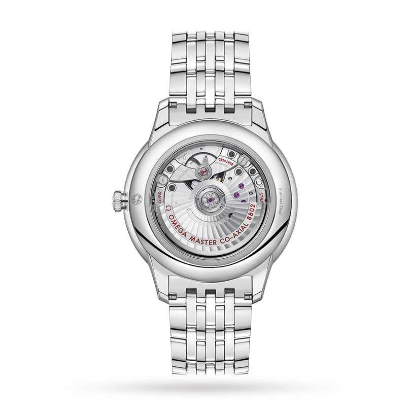 The back of the OMEGA De Ville Prestige displays its classic design, featuring the exposed Co-Axial Calibre 8802 movement with engraved details and visible gears through a transparent case back.