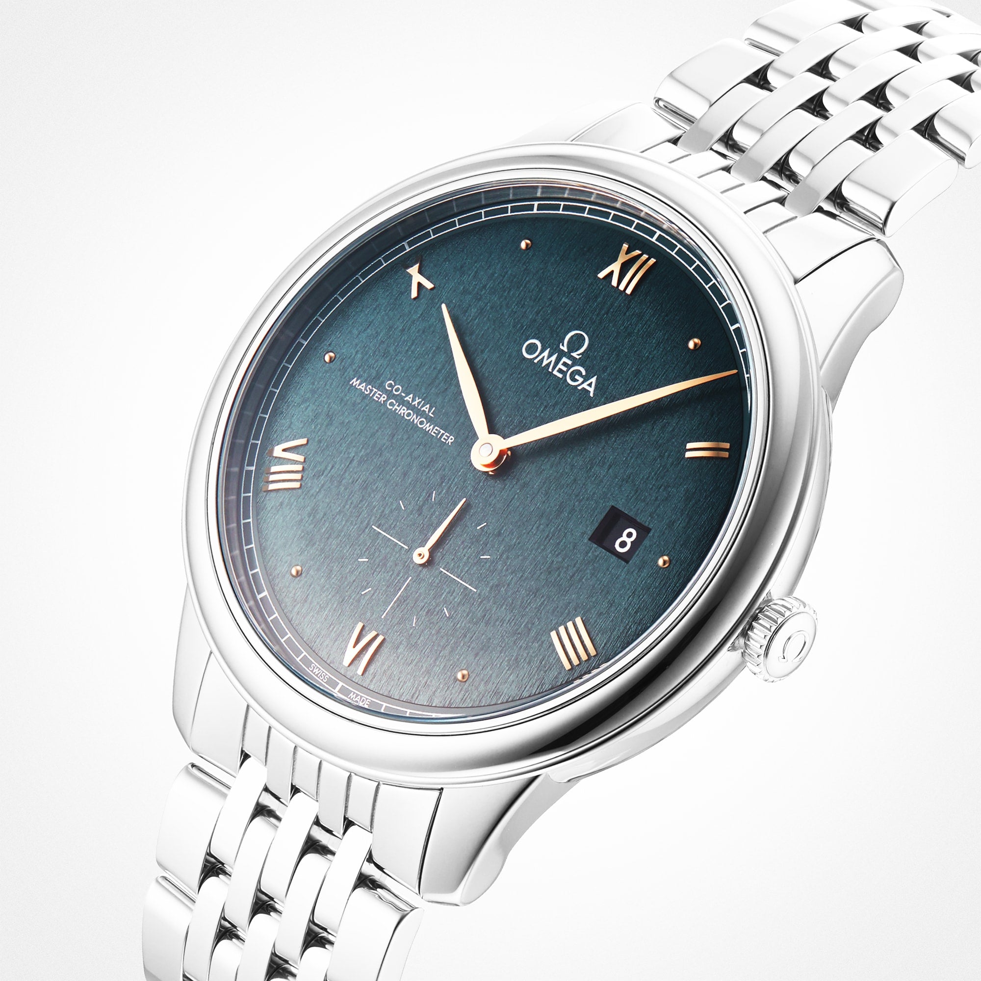 The OMEGA De Ville Prestige wristwatch features a silver case, blue dial with Roman numerals, date window at 3 o’clock, subdial at 6 o’clock, and a metal link bracelet, radiating refined elegance on a white background.