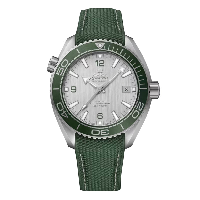 The OMEGA Seamaster Planet Ocean 600M is a silver dive watch with a green bezel, textured strap, white dial, silver hour markers, and certified Co-Axial Master Chronometer precision.