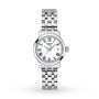 The Tissot Classic Dream features a silver-tone metal link band, white dial with Roman numerals, date window at 3 oclock, and precise Swiss quartz movement—an elegant timepiece blending luxury and style.