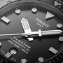 Close-up of the Tissot Seastar 1000 Powermatic 80 watch face, showing hands, markers, date window, and brand logo on a textured dial with Powermatic 80 movement.