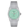 The Tissot PRX features a stainless steel case, mint green dial, silver hour markers and hands, date window at 3 o’clock, and a sleek metal bracelet.
