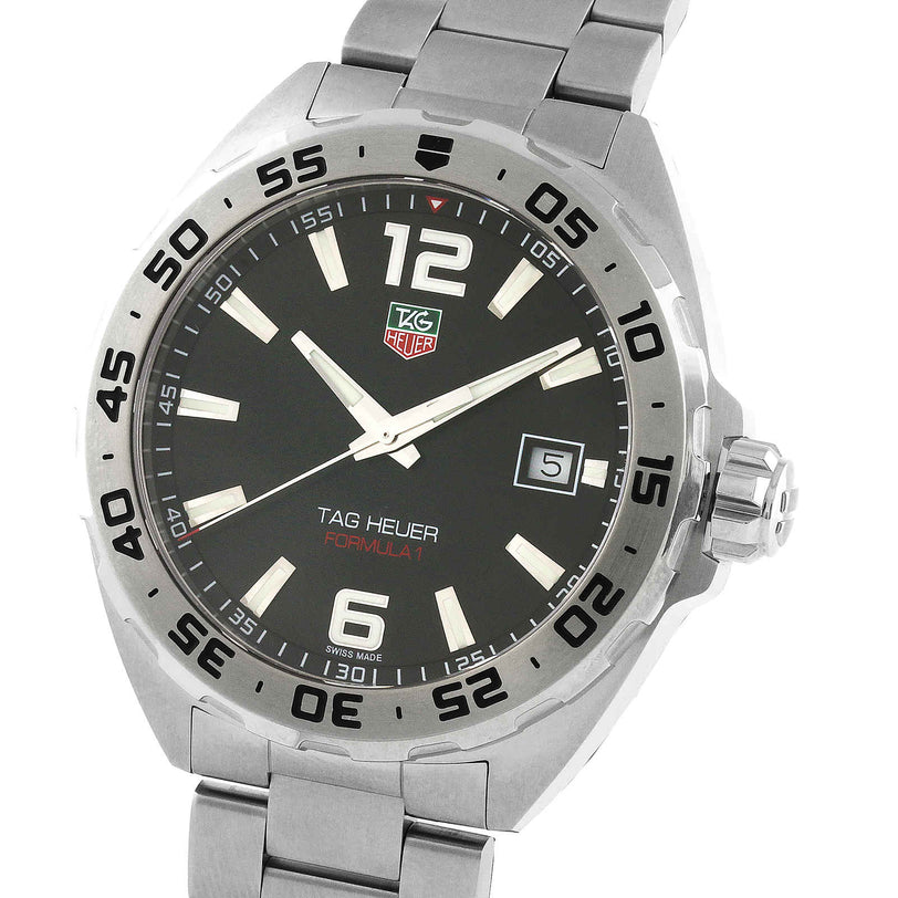 A close-up of the TAG Heuer Formula 1 Date wristwatch, featuring a black dial, silver hour markers, date display, stainless steel band, and precise quartz movement.
