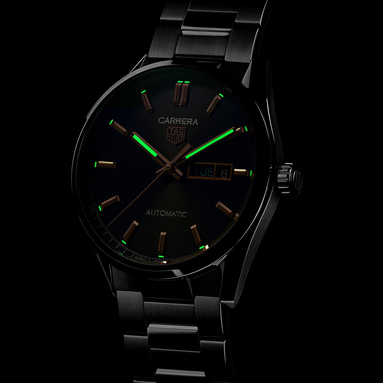 A TAG Heuer Carrera Day-Date watch featuring luminous markers that glow green in the dark.