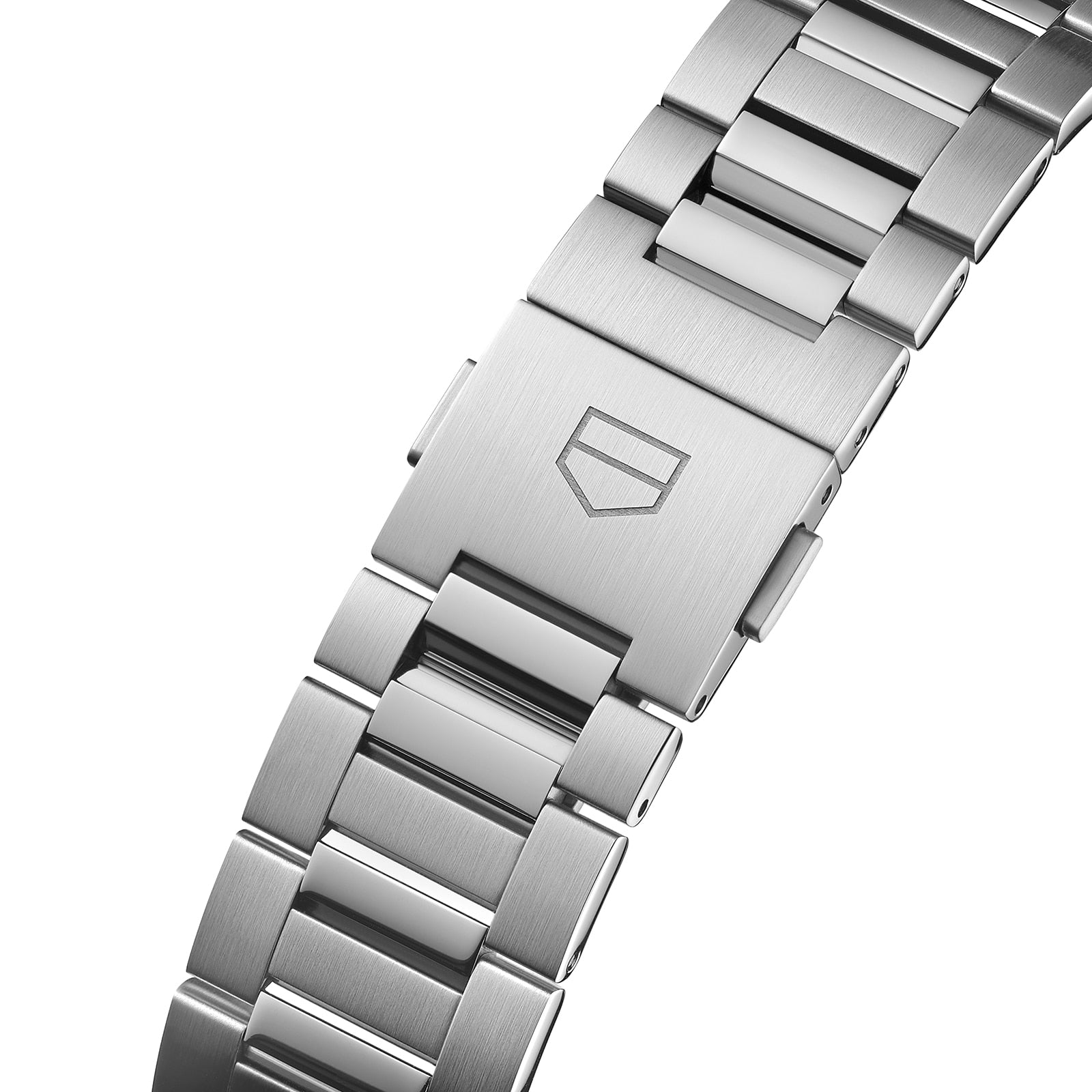 Close-up of a stainless steel Carrera Twin-Time bracelet by TAG Heuer, featuring a clasp with the shield logo and highlighting its signature design and automatic movement.