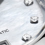 Close-up of a TAG Heuer Carrera Date watch face, showing diamond hour markers and part of the word AUTOMATIC.