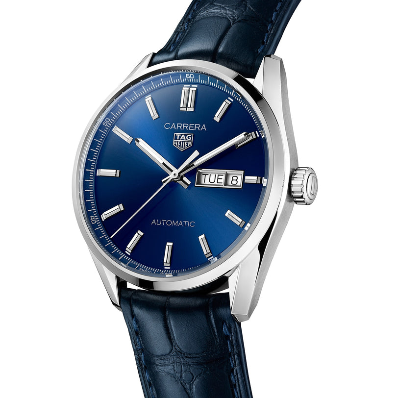 The TAG Heuer Carrera Day-Date features a blue dial, silver hour markers, date and day display, calibre 5 automatic movement, and a blue alligator leather strap.