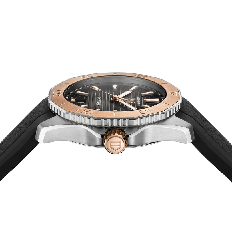 A close-up side view of the TAG Heuer Aquaracer Professional 200 showcases its black strap, silver case, and rose gold bezel and crown. The dark dial features metallic markers and hands, driven by a calibre 5 automatic movement.