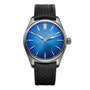 The H. Moser & Cie Pioneer Centre Seconds is a sporty-chic automatic watch with an Arctic Blue fumé dial, silver markers and hands, stainless steel case, and black perforated strap.
