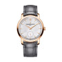 The Vacheron Constantin Traditionnelle Manual-winding, a limited edition 18K pink gold watch with silver dial, black hour markers, small seconds subdial, and gray leather strap is shown elegantly on a white background.