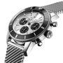 A close-up of the Breitling Superocean Heritage B01 Chronograph 44 with a silver mesh band, black bezel, and three subdials on a silver face, highlighting its water-resistant design.