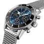 A close-up of the Breitling Superocean Heritage B01 Chronograph 44 featuring a blue dial with three subdials, powered by the Breitling 01 calibre, black bezel, and a mesh stainless steel band.