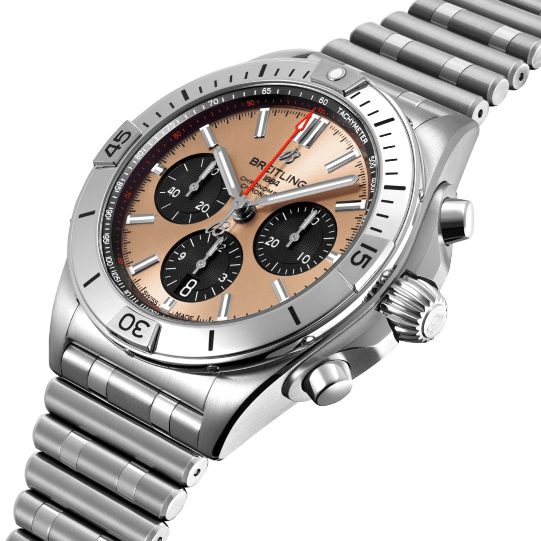 The Breitling Chronomat B01 42 is a stainless steel chronograph watch with a bronze dial, three black subdials, Breitling 01 movement, and a metal link bracelet.