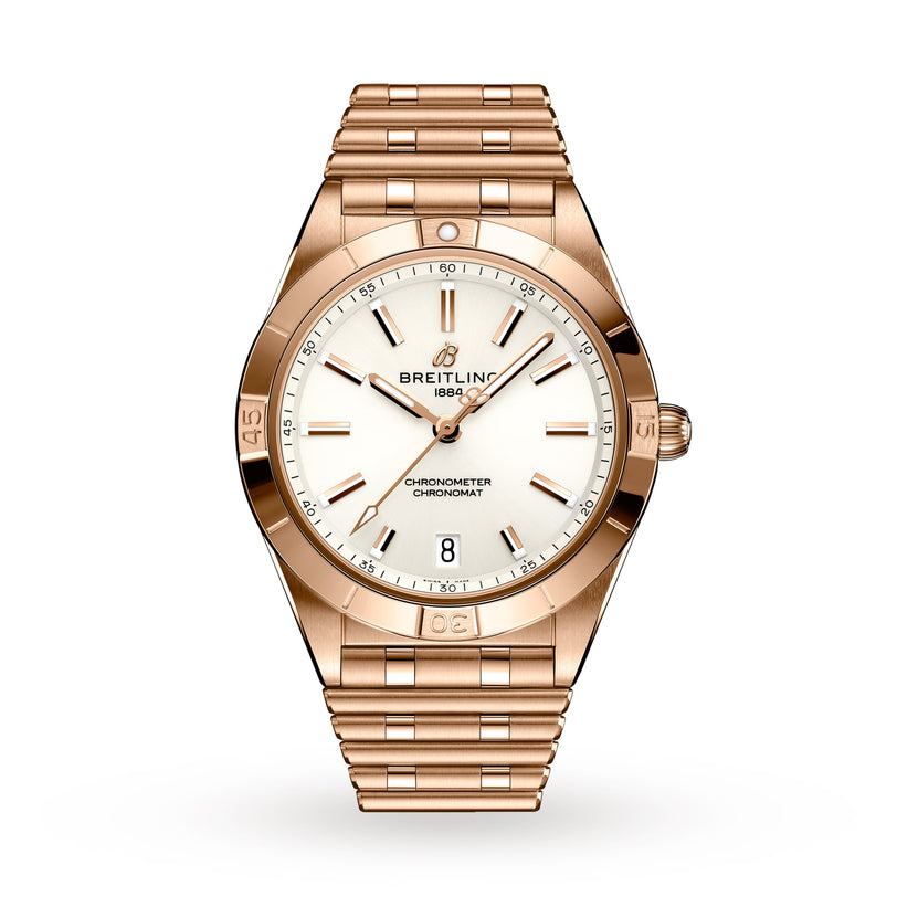The Breitling Chronomat Automatic 36 features a gold case, white dial with gold markers and hands, date display at 6 o’clock, and signature Rouleaux linked bracelet for a classic look.