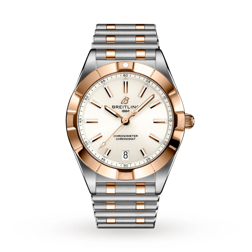 The Breitling Chronomat 32 features a silver and gold two-tone metal band, white dial, gold bezel, and date at 6 o’clock. This COSC-certified chronometer is shown against a plain white background.