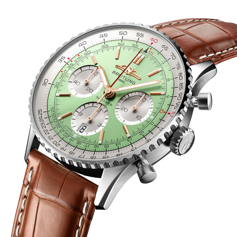The Breitling Navitimer B01 Chronograph 41 features a light green dial with three chronograph subdials, a date window, silver bezel, and brown leather strap. The Breitling brand name appears prominently on the watch face.