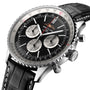 Close-up of a Breitling Navitimer B01 Chronograph 46 wristwatch featuring a black dial, three subdials, date window, and a black leather strap with white stitching.