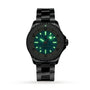 A Breitling Superocean Automatic 36 black dive watch with a metal band and ceramic bezel, featuring glowing green luminescent hands and hour markers, displayed on a white background.