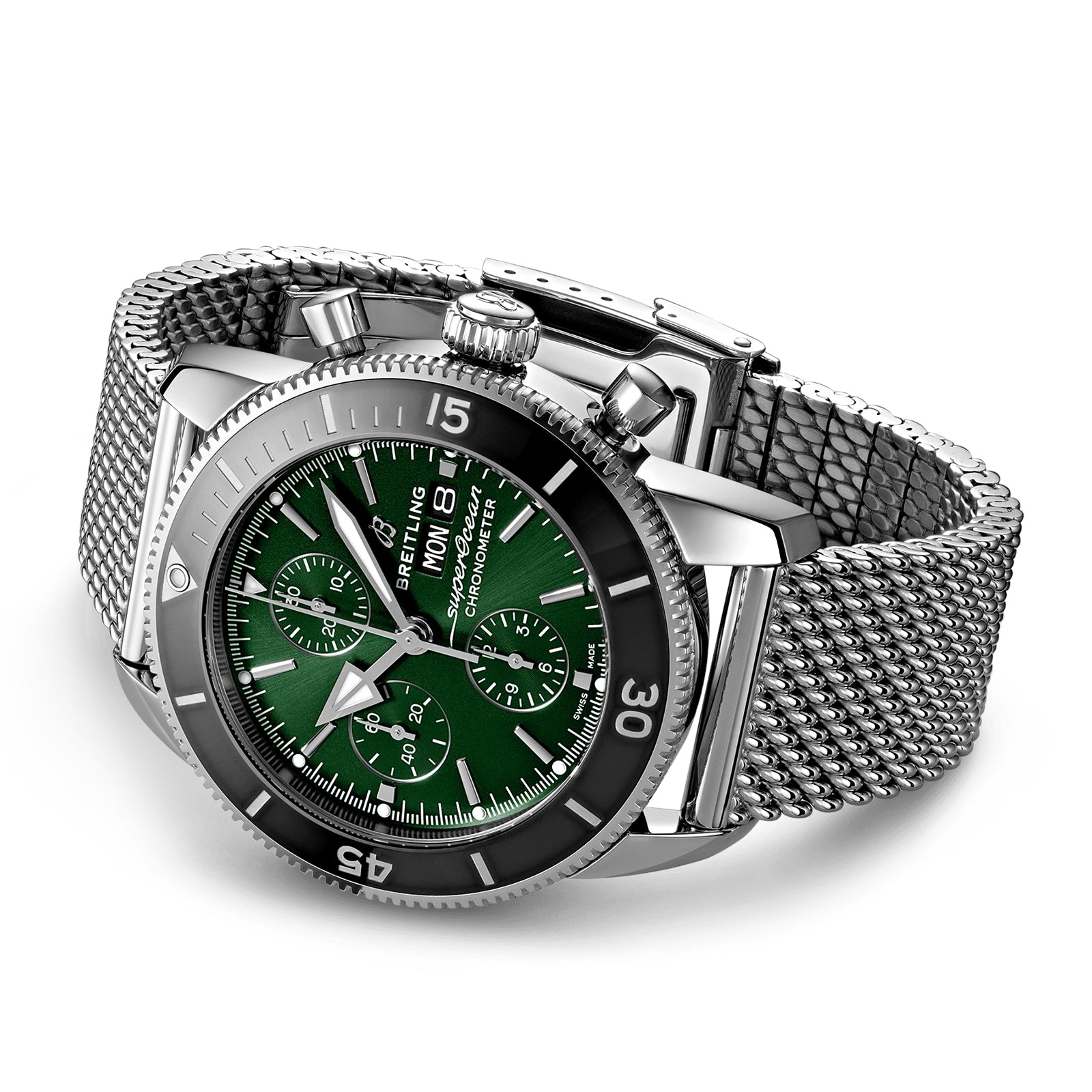 The Breitling Superocean Heritage Chronograph 44 is shown at an angle on a white background, featuring a green dial with three subdials, date and day display, mesh bracelet, stainless steel case, and Breitling 13 calibre movement.