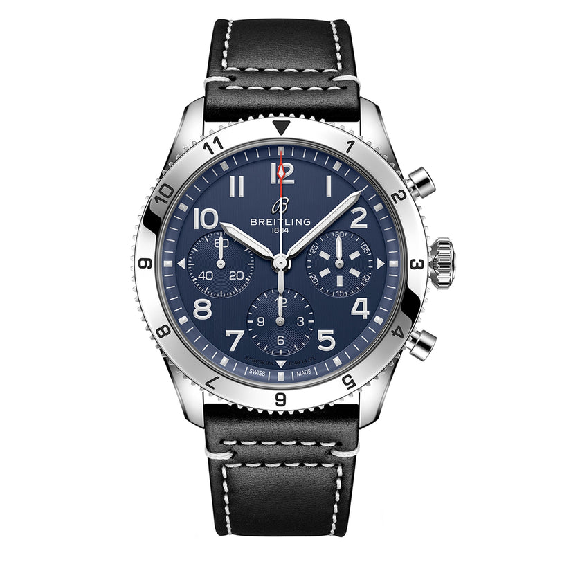 The Breitling Classic AVI Chronograph 42 Tribute To Vought F4U features a blue dial with white numerals, three subdials powered by the Breitling 23 calibre, a black leather strap with white stitching, and a silver bezel.