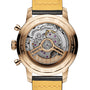 Close-up of the Breitling Top Time B01’s transparent case back, revealing its intricate automatic movement and gold accents.