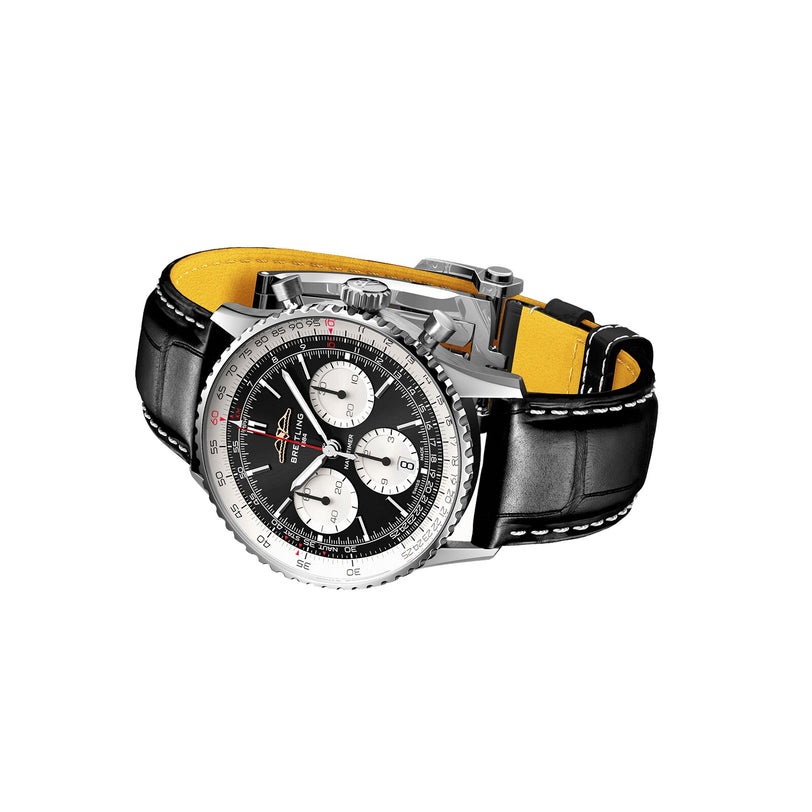 The Breitling Navitimer B01 Chronograph 41 is a stainless steel pilot’s watch with a black dial, three subdials, B01 chronograph movement, and a black leather strap with white stitching and yellow inner lining.