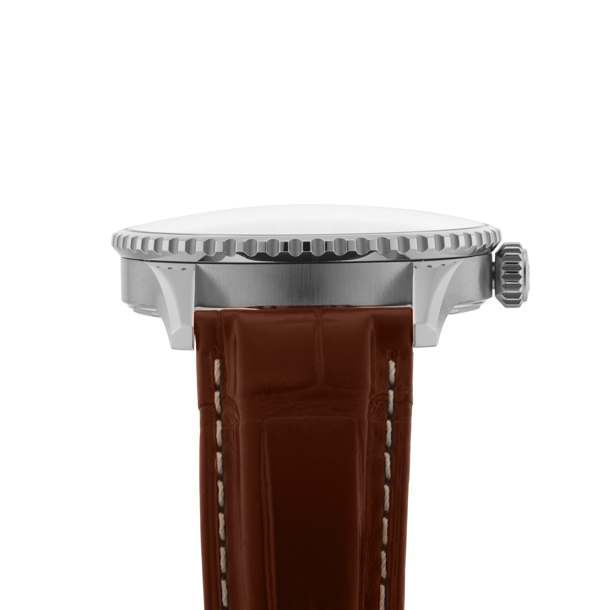 Side view of the Breitling Navitimer Automatic GMT 41, showcasing its 41mm stainless steel case, textured bezel, crown, and brown leather strap with white stitching inspired by classic aviator style.